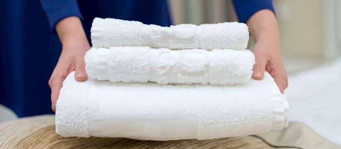 Woman Changing Hotel Room Towels Min